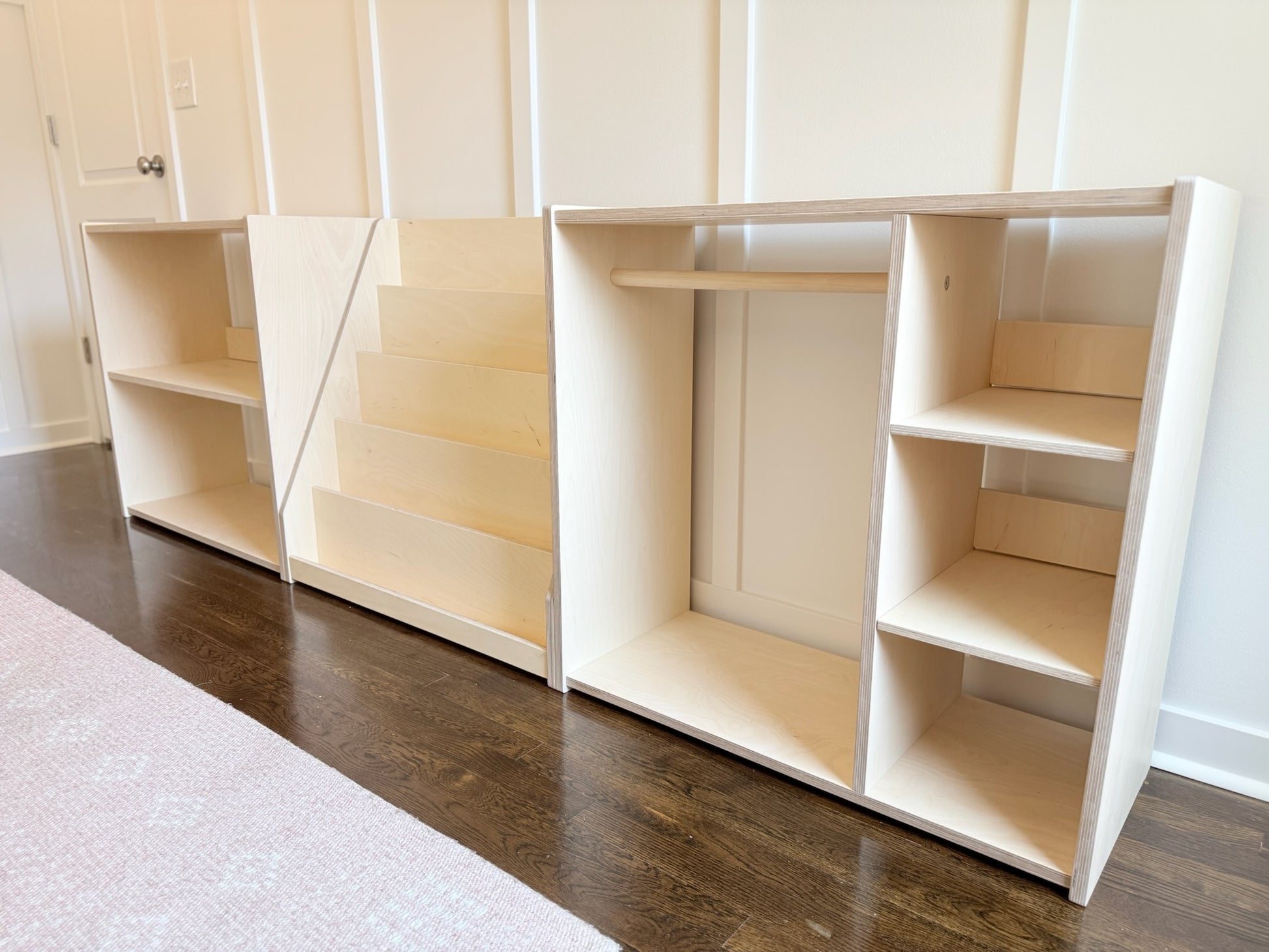 System of natural birch children's shelves against a white wall