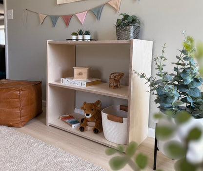Children's toy shelf with various toys, books, children's items in styled room.