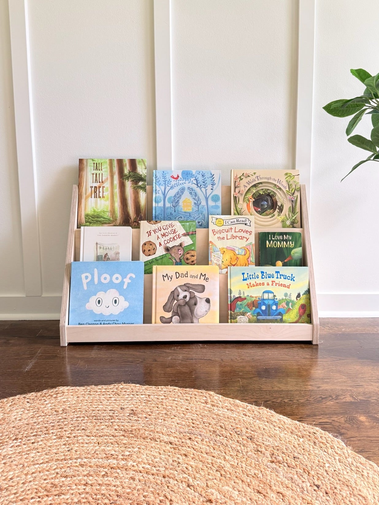 Wooden bookshelf with children's books in bright room