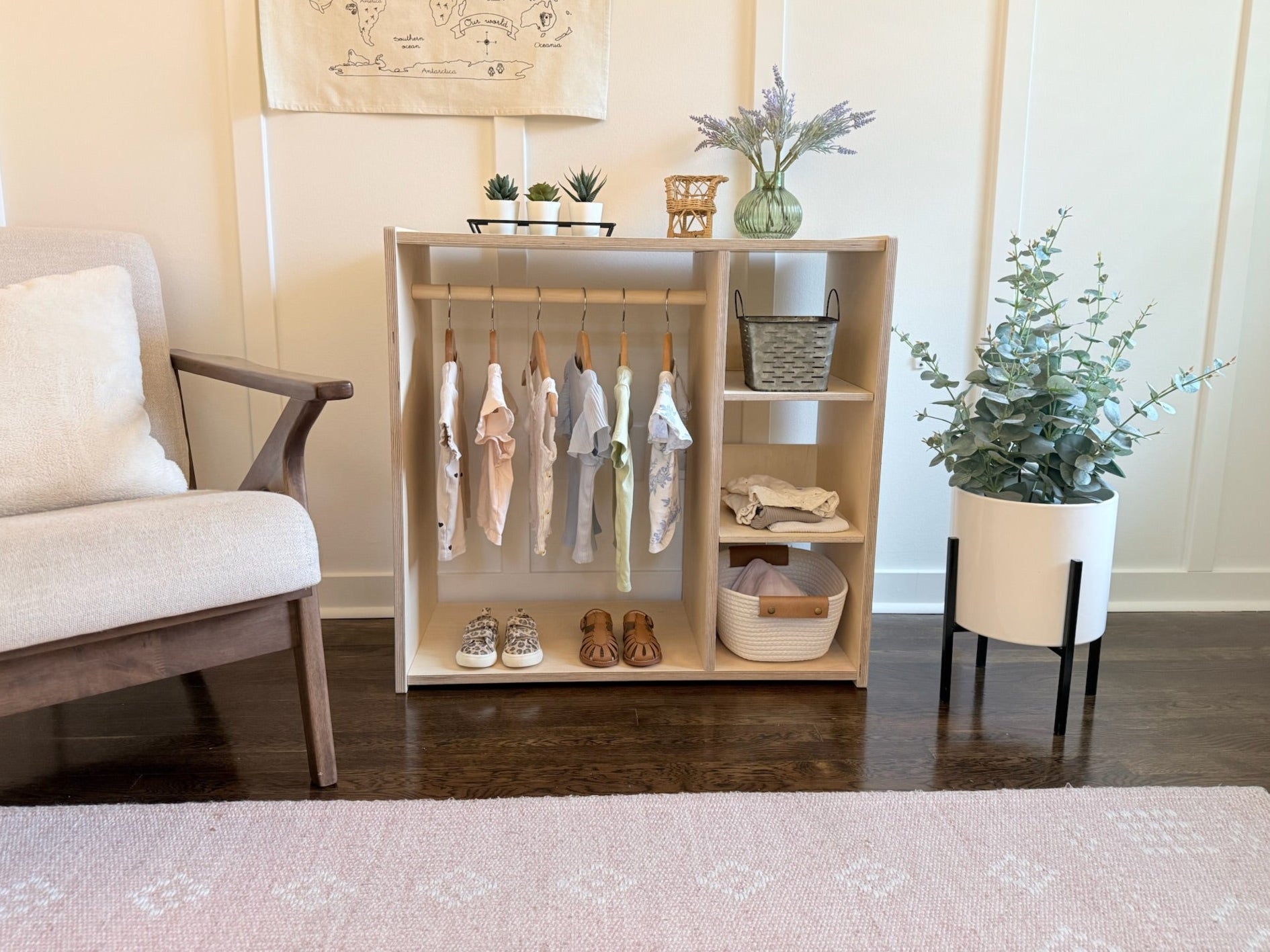 Wooden clothing rack with clothes and shoes in a modern room setting