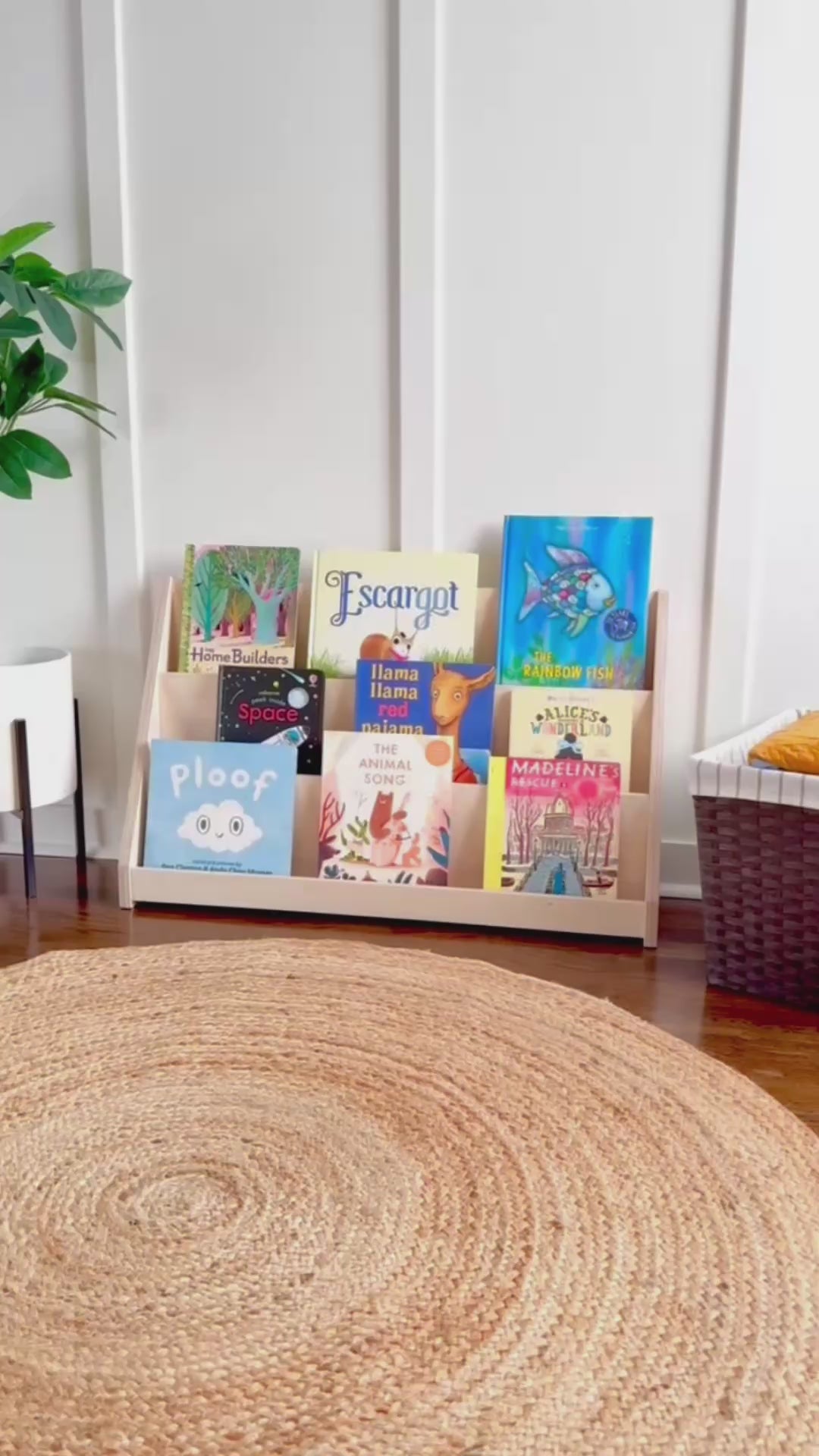 Video showing adult and child using small wooden bookshelf